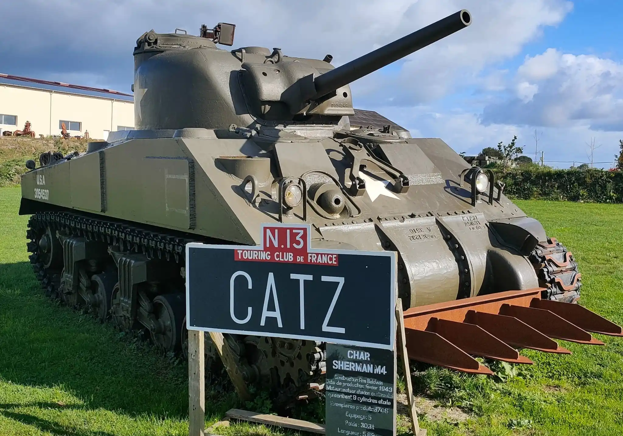 Sherman M4 tank equipped with a hedge cutter in front of the Normandy Victory Museum