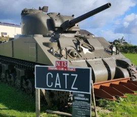 Sherman M4 tank equipped with a hedge cutter in front of the Normandy Victory Museum